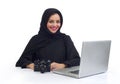 Arabian photographer working on her Laptop at the office