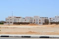 Arabian rectangular houses in the desert with windows against the background of yellow sand and blue sky in Egypt and black and wh Royalty Free Stock Photo