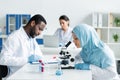 Arabian scientist working with microscope near Royalty Free Stock Photo