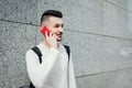 Arabian student calling friends outside. Smiling man waiting for groupmates after classes Royalty Free Stock Photo