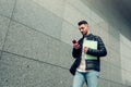 Arabian student using smartphone outside. Young man going to university