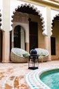 Arabian style tiled floor in a green hammer with brown bricks floor and relaxing sofa and black lamp in a Riyadh in Marrakesh, Mor