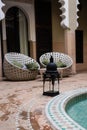 Arabian style tiled floor in a green hammer with brown bricks floor and relaxing sofa and black lamp in a Riyadh in Marrakesh, Mor