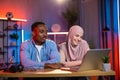 Arabian woman and african man having video call on laptop Royalty Free Stock Photo