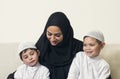 Arabian woman holding her children, mother and sons
