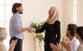 Arabian worker handshaking boss get rewarded for good work result