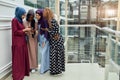Arabian young women watching on cellphone musical video clip standing together. Royalty Free Stock Photo