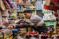 Arabic aged shopkeeper from Iran arranging food items in his shop at souk mubarakiya, Kuwait City