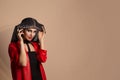 Arabic Beauty Arabic woman in red jacket looking at you smiling raising taking off her black hood decorated with crystals isolated