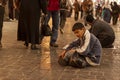 An Arabic boy is sitting on the floor of Al hamidiyah souq