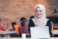 Arabic business woman wearing hijab,working in startup office.