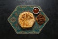 Arabic Cheese Bread with dates on a black table. Royalty Free Stock Photo