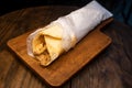 Arabic Chicken shawarma roll wrap isolated on wooden board top view arabic spicy fastfood