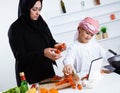 Arabic child in the kitchen with his mother Royalty Free Stock Photo