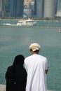 Arabic couple enjoying the view of the harbor in a big city