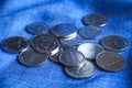 Arabic coins of dirhams. Curled banknotes in his hands.