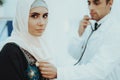 Arabic Doctor Checking Heartbeat a Muslim Woman