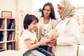 Arabic Doctor Giving Toy to Little Cute Patient. Confident Muslim Female Doctor. Child at the Pediatrician. Hospital Concept.