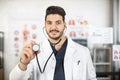 Arabic doctor holding stethoscope and smiling on camera