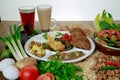 Arabic Dynamite breakfast platter with flafel, marinated fried eggplant, mashed potato, hummus, foul, beans, pita bread, salad and