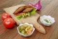 Arabic Dynamite Falafel and Eggplant Sandwich with bell pepper, onion, tomato, dip, hummus, veggies and fires isolated on wooden Royalty Free Stock Photo