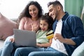Arabic Family Of Three With Laptop And Credit Card Making Online Shopping Royalty Free Stock Photo