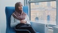 Arabic female Intern student in hijab waiting for exam or interview results in armchair. Job candidate sits at recruit Royalty Free Stock Photo