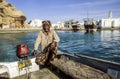 Arabic ferry man transports passenger in an old traditional boat