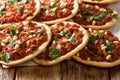 Arabic food Esfiha mini pizza with meat and pine nut closeup. Horizontal Royalty Free Stock Photo