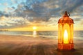 Arabic lantern on sea beach at beautiful sunset sky with cloud, Ramadan kareem backgrounds