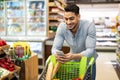 Arabic Male Buying Groceries Online Shopping Via Phone In Supermarket Royalty Free Stock Photo