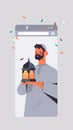 Arabic man holding lantern celebrating online birthday party celebration self isolation quarantine concept