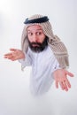 Arabic man in national dress smiles and is surprised. Mouth and eyes wide open. Emotions colorful people Royalty Free Stock Photo