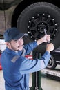 Arabic mechanic replacing a car wheel Royalty Free Stock Photo