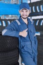 Arabic mechanic with tires shows thumb up Royalty Free Stock Photo