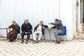 arabic men sitting in front of entrance to the old covered suq in Hawna as Suq in a typical arabic tea house