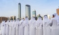 Arabic men standing in traditional cloth around modern buildings - Middle Eastern Culture - Emirati Men performing Al Ayala