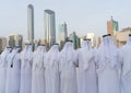 Arabic men standing in traditional cloth around modern buildings - Middle Eastern Culture - Emirati Men performing Al Ayala