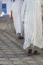Arabic men walking in their traditional clothes thobe