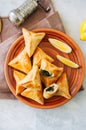 Arabic and middle eastern food concept. Fatayer sabanekh - traditional arabic spinach triangle hand pies on a white stone