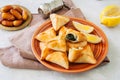 Arabic and middle eastern food concept. Fatayer sabanekh - traditional arabic spinach triangle hand pies on a white stone