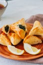 Arabic and middle eastern food concept. Fatayer sabanekh - traditional arabic spinach triangle hand pies on a white stone