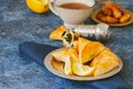 Arabic and middle eastern food concept. Fatayer sabanekh - traditional arabic spinach triangle hand pies on a blue stone