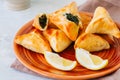 Arabic and middle eastern food concept. Fatayer sabanekh - traditional arabic spinach triangle hand pies dates and tea on a white Royalty Free Stock Photo