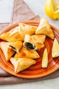 Arabic and middle eastern food concept. Fatayer sabanekh - traditional arabic spinach triangle hand pies dates and tea on a white