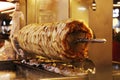 Arabic middle eastern street food shawarma rolling on top of fire