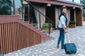 Young Guy Arab Businessman Student Came go to Restaurant With Suitcase in Hand, Smiling at Camera, Stops and Looks Away. Royalty Free Stock Photo