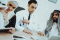 Arabic Patient Giving Euros Money to Doctor. Royalty Free Stock Photo