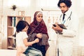 Arabic Pediatrician Appointment Mom with Sick Son. Confident Muslim Male Doctor. Hospital Concept. Healthy Concept. Pediatrician Royalty Free Stock Photo