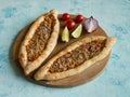 Arabic pizza Lahmacun on blue background.